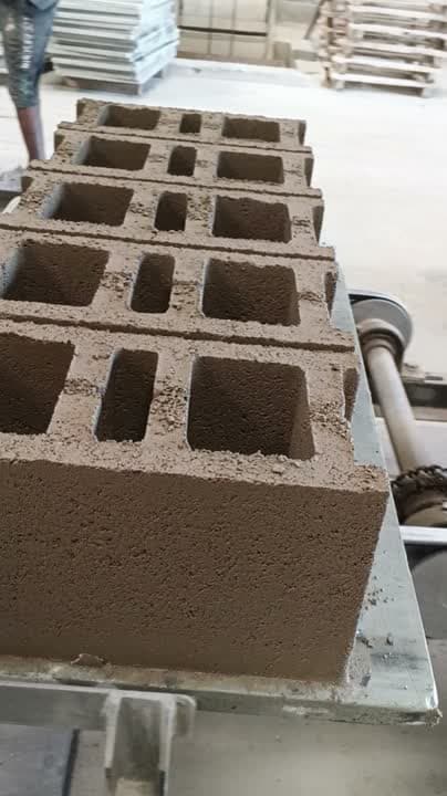 Hollow blocks being cast and moved off the press at the Namanve factory