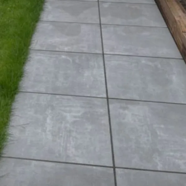 Concrete slabs laid as a path beside a lawn edge